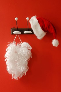 Santa hat and beard hanging on nostalgic coat hooks