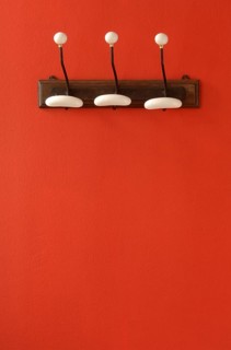 Nostalgic coat hooks on red wall