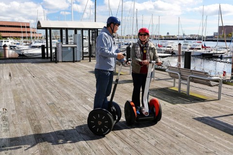 Tourists riding segways round the port