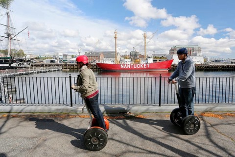 Tourists riding segways round the port