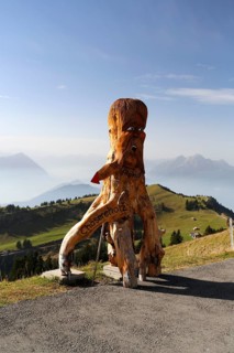 Wooden figure as a guide to a cheese factory