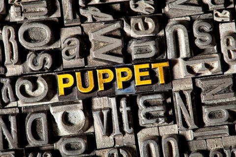 Old lead letters forming the word "PUPPET"