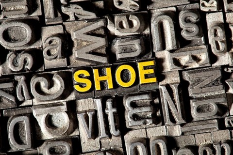 Old lead letters forming the word 'SHOE'