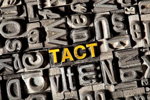 Old lead letters forming the word 'TACT'