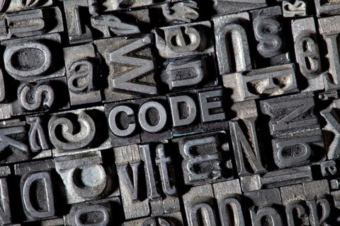 Old lead letters forming the word CODE