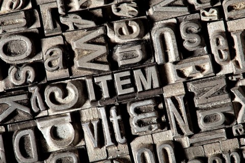 Old lead letters forming the word 'ITEM'