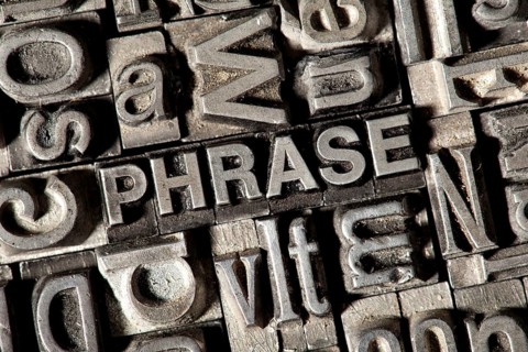 Old lead letters forming the word "PHRASE"