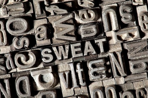 Old lead letters forming the word 'SWEAT'