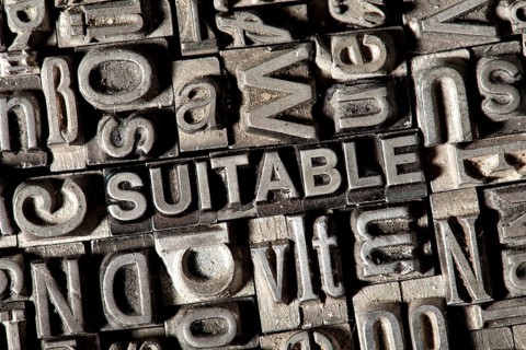 Old lead letters forming the word 'SUITABLE'