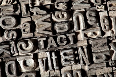 Old lead letters forming the word TACT
