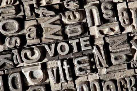 Old lead letters forming the word VOTE