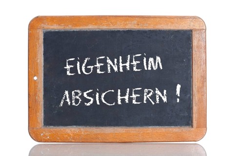 Old school blackboard with the words EIGENHEIM ABSICHERN!