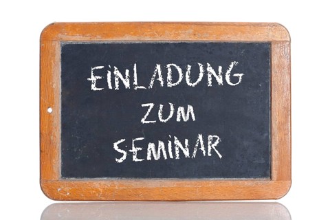 Old school blackboard with the words EINLADUNG ZUM SEMINAR