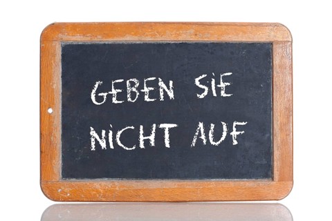 Old school blackboard with the words GEBEN SIE NICHT AUF