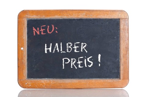 Old school blackboard with the words NEU: HALBER PREIS!
