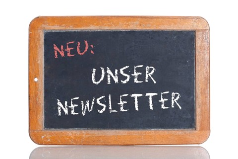 Old school blackboard with the words NEU: UNSER NEWSLETTER