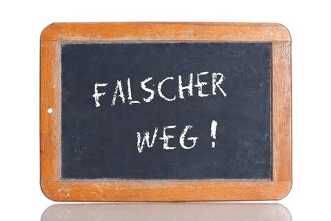 Old school blackboard with the term FALSCHER WEG