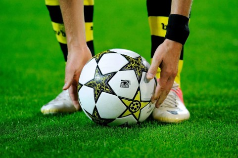 BVB player taking the Champions League ball into his hands