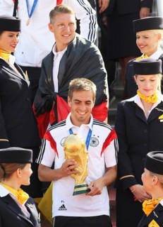 Philipp Lahm with the trophy and Bastian Schweinsteiger