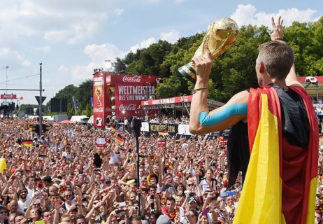 Bastian Schweinsteiger shows the fans the trophy
