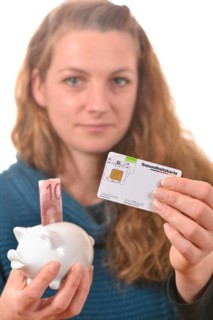 Woman holding a health insurance card and a 10 euro banknote