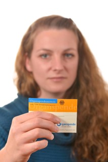 Woman holding an organ donor card