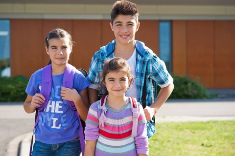 Children carrying school bags on the way to school