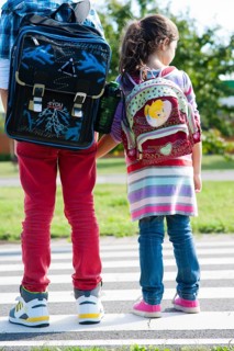 Children carrying school bags on the way to school