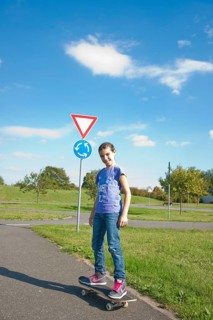 Girl riding a skateboard on a street
