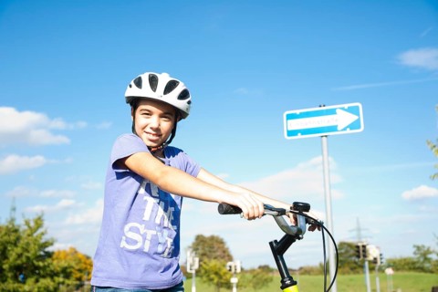 Girl wearing a bike helmet at a traffic awareness course