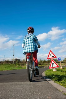 Child approaching a construction site sign at a traffic awareness course
