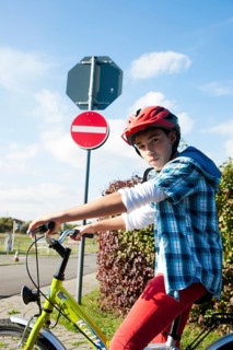 Boy wearing a bike helmet at a traffic awareness course