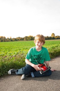 Boy playing with his radio-controlled model car