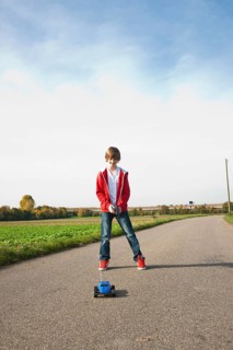 Boy playing with his radio-controlled model car