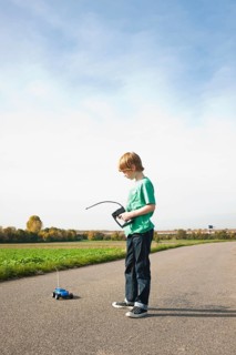 Boy playing with his radio-controlled model car