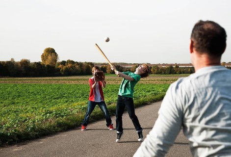 Father playing baseball with his sons