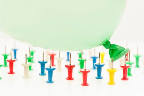 Balloon falling on pins