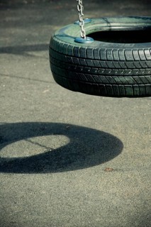 Empty swing made from a tyre at playground