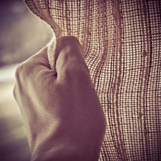 Hand opening or closing a curtain