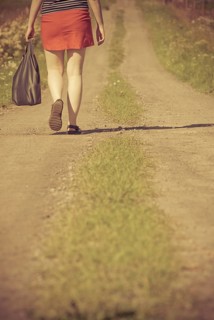 Woman walking on a dirt road