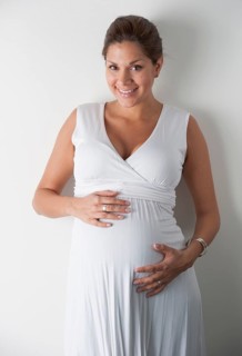 Pregnant woman holding hands on her stomach