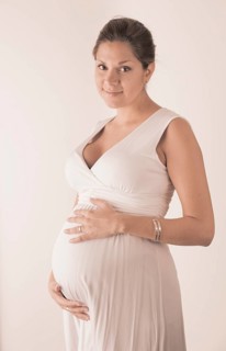 Pregnant woman holding hands on her stomach