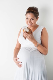Pregnant woman eating a cinnamon roll