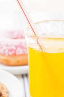 Glass of orange soda with drinking straw