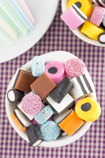 Bowls filled with liquorice candy and drinking straws