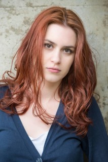 Portrait of a confident young woman with red hair