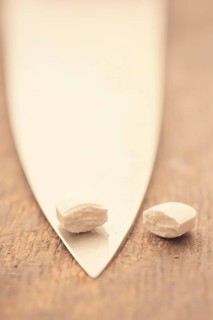 Medical capsule divided into two halves by large knife