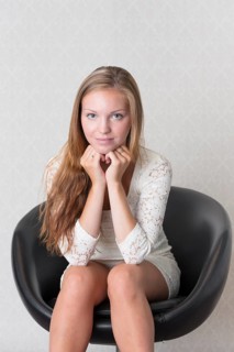 Young woman sitting in a vintage chair