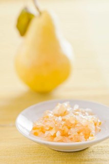 Fruit jam made from pears with a fresh pear in the back