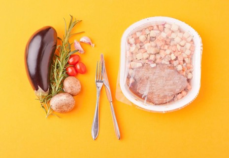 Fresh healthy vegetables next to microwave meal